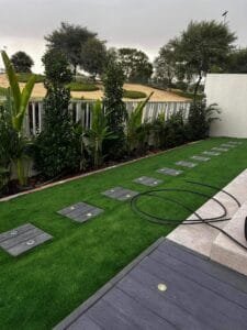 Composite deck walkway with embedded LED lighting and artificial turf, Dubai Hills Estate villa overlooking the golf course
