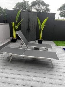Outdoor shower and sun loungers on composite decking, Dubai Hills Estate villa