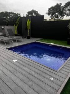 Overview of finished swimming pool, composite decking, and outdoor shower area, Dubai Hills Estate villa