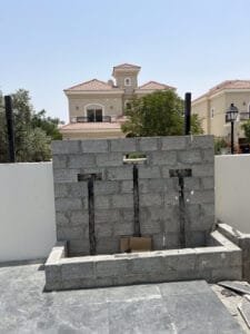 Water feature wall under construction with plumbing for cascading jets, Jumeirah Golf Estates villa